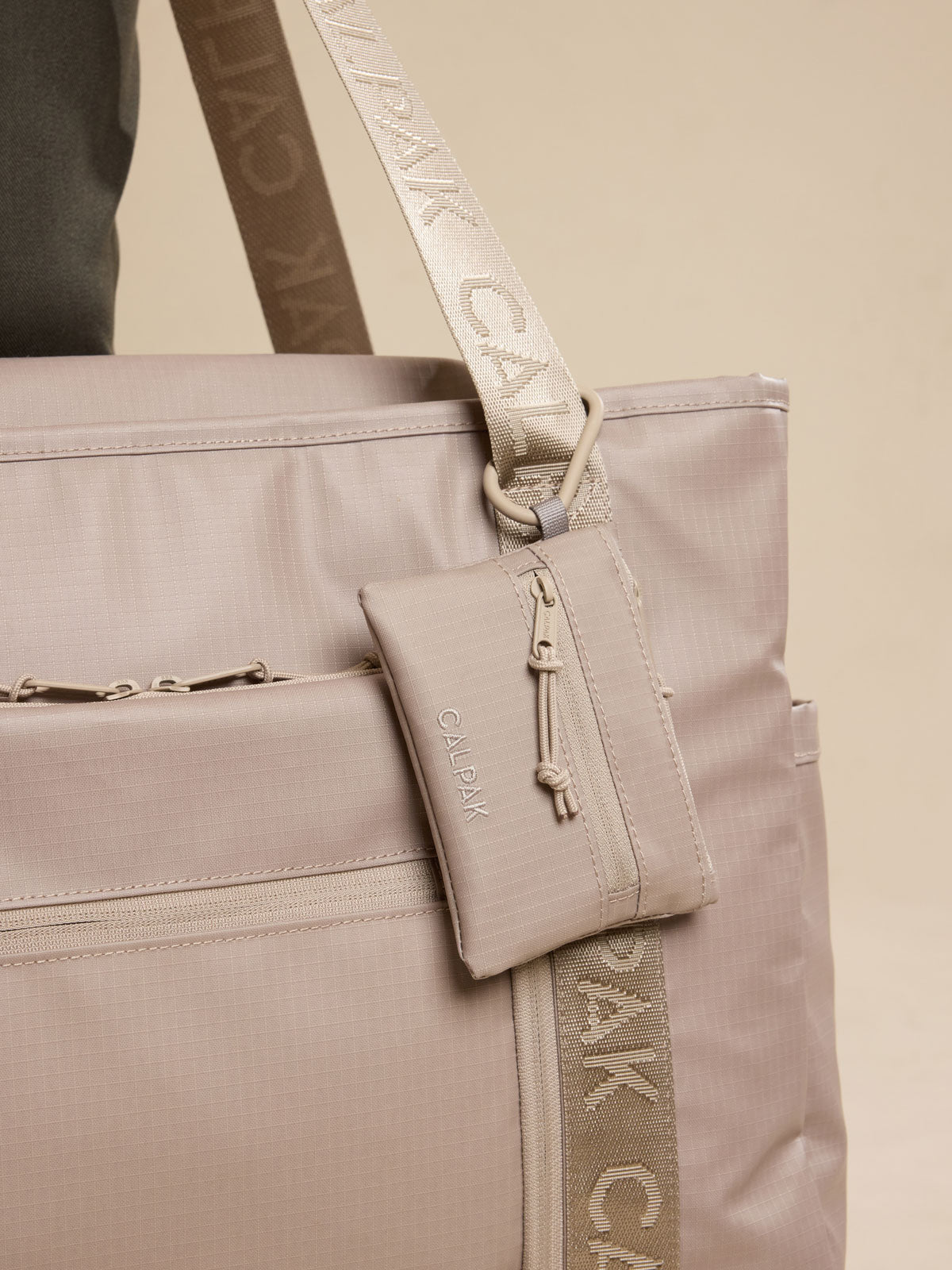 CALPAK Terra Clippable Card Pouch in beige Stone clipped onto bag; TPC2401-STONE