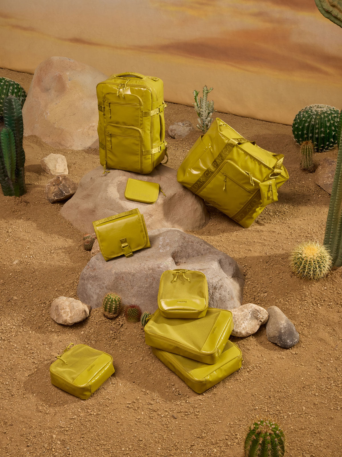 CALPAK Terra 5pc Packing Cube Set and other Terra items in yellow green Wasabi in a desert  themed background; PCT2601-WASABI