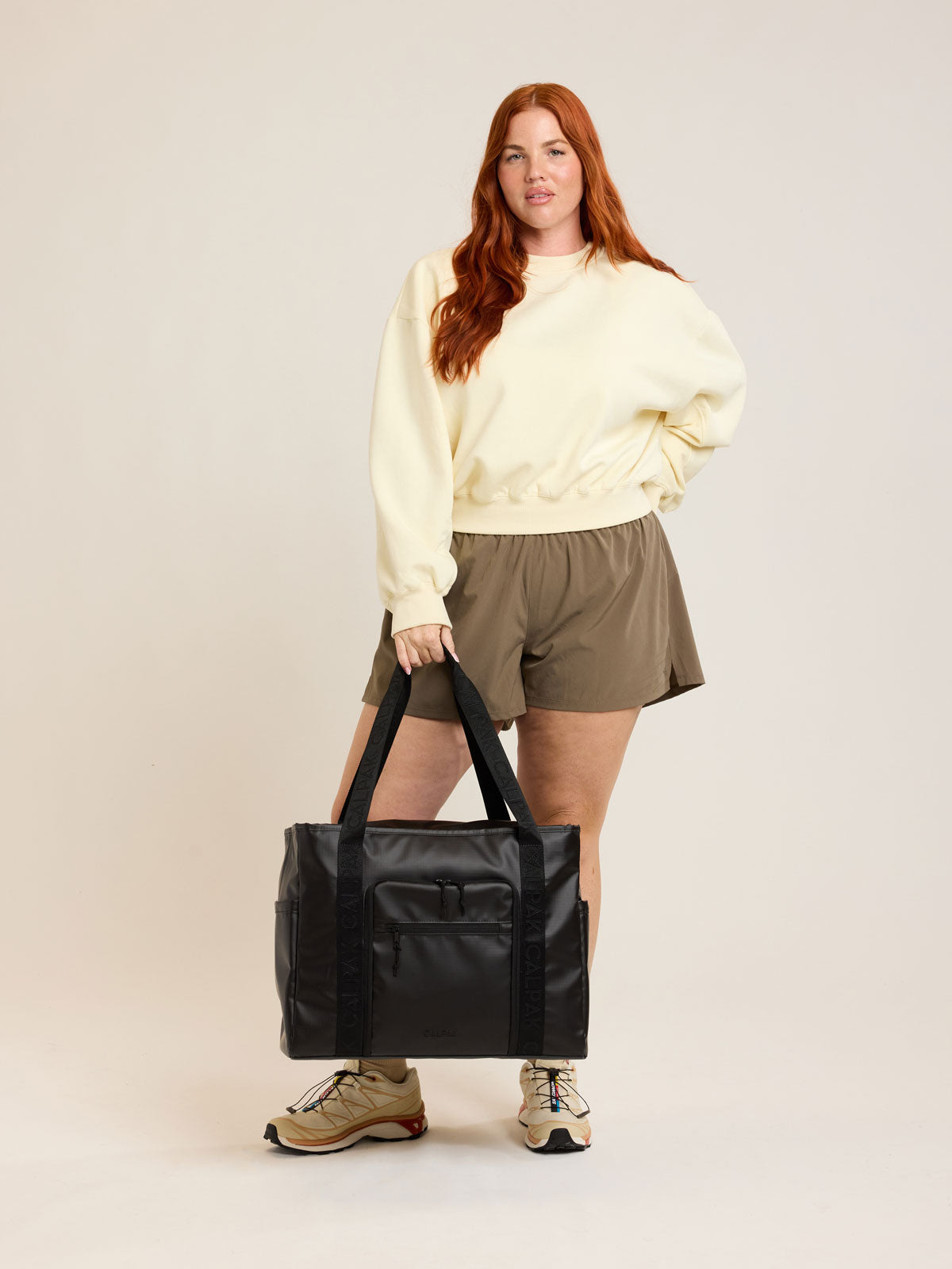 Model with CALPAK Terra 35L Tote in black Matte Obsidian; TTO2401-MATTE-OBSIDIAN
