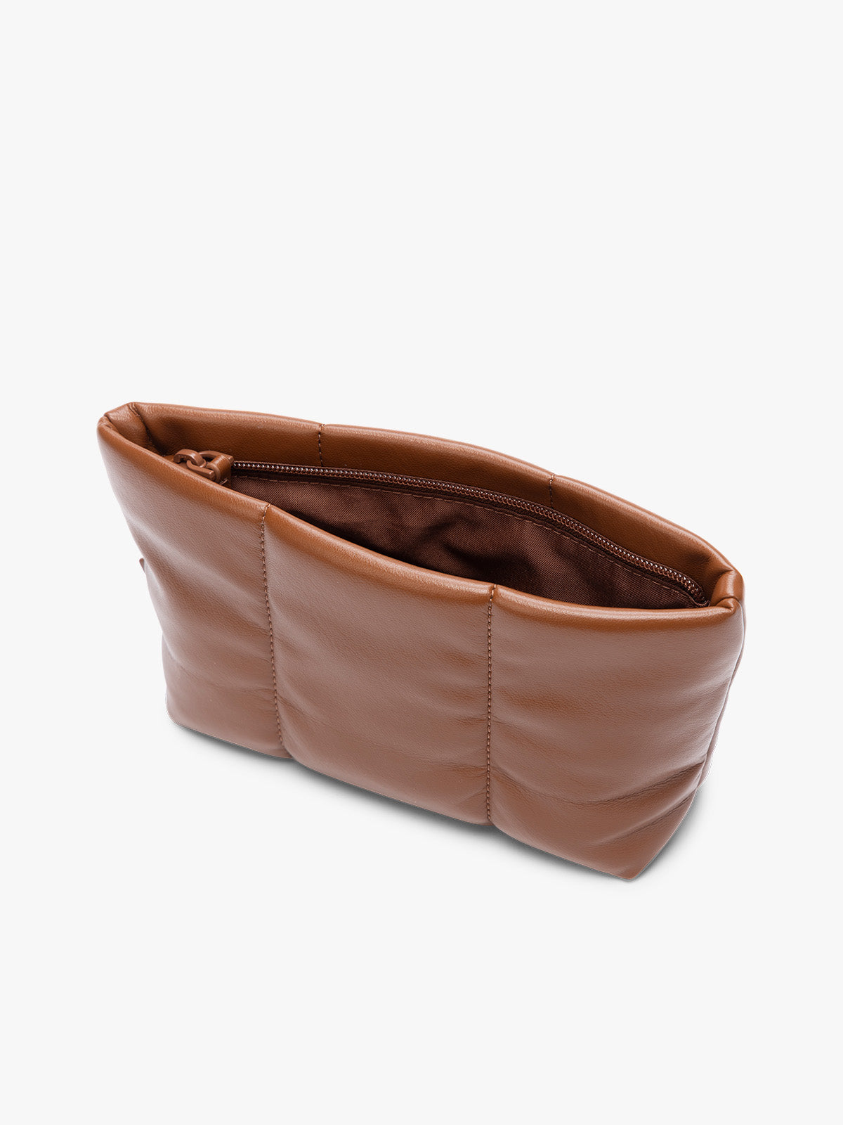 Opened zipper of a CALPAK Luka 1 quart light brown Honey Brown vegan leather pouch bag with a quilted, padded design and a small brand tag on the right side, shown against a plain white background; ZLPS2601-HONEY-BROWN-PU