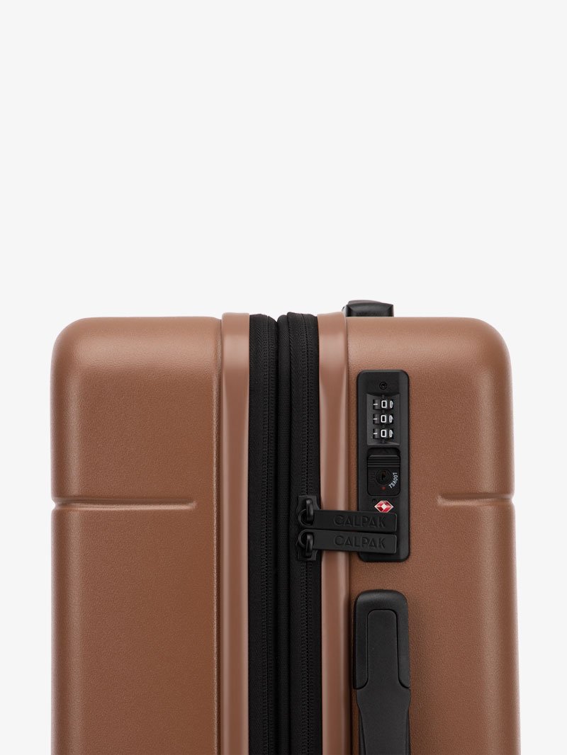 TSA lock of CALPAK Hue hard shell rolling carry-on luggage in brown hazel color; LHU1020-NP-HAZEL